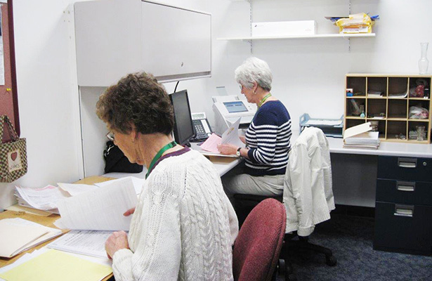 Volunteers doing office work